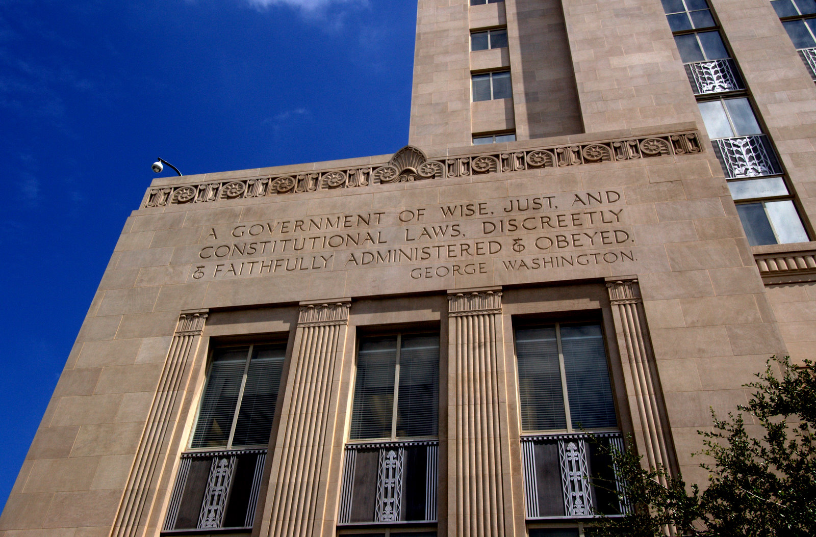 A tall building with windows and a sky background